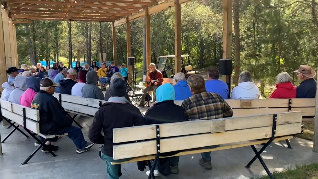 Mike Birkeland sharing songs, stories and truth that transforms at the Lakes Bluegrass Festival near Pine River, MN.